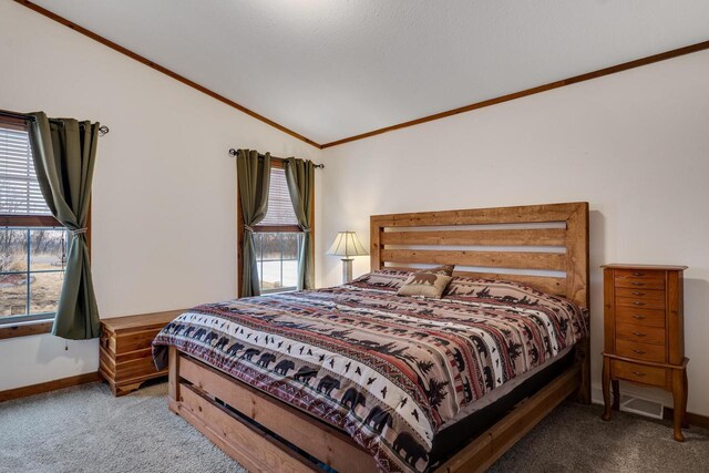 bedroom with baseboards, crown molding, carpet, and vaulted ceiling