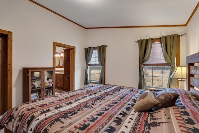 bedroom with connected bathroom and ornamental molding