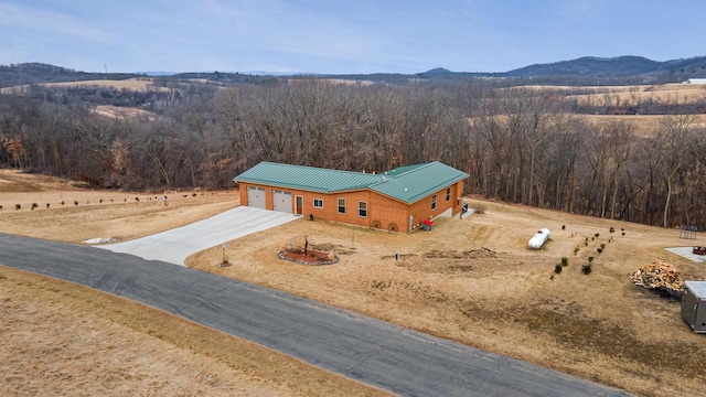 aerial view with a mountain view and a wooded view