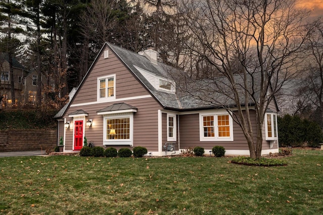 view of front of property featuring a chimney and a front lawn