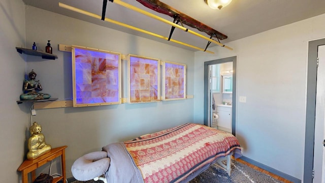 bedroom with baseboards and ensuite bath