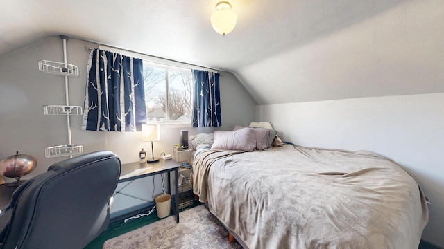 carpeted bedroom with vaulted ceiling