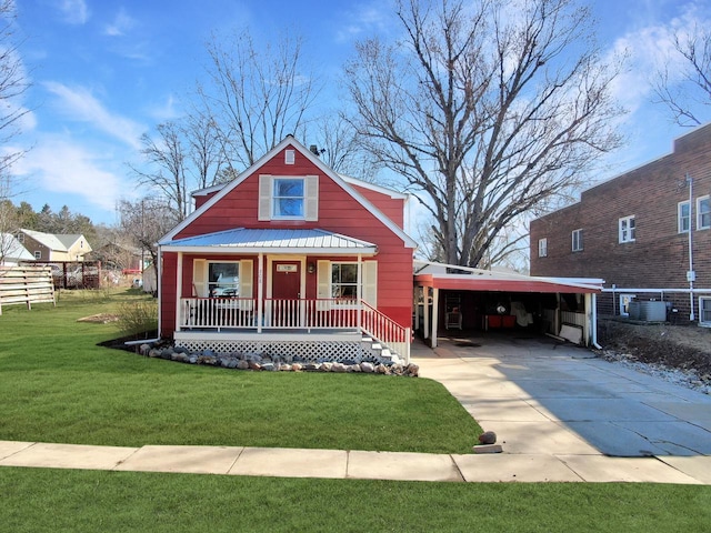 bungalow featuring an attached carport, a front yard, cooling unit, driveway, and covered porch