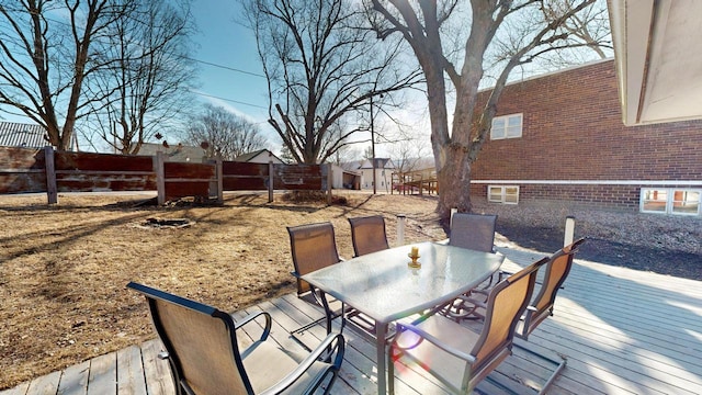 deck with outdoor dining area and a fenced backyard