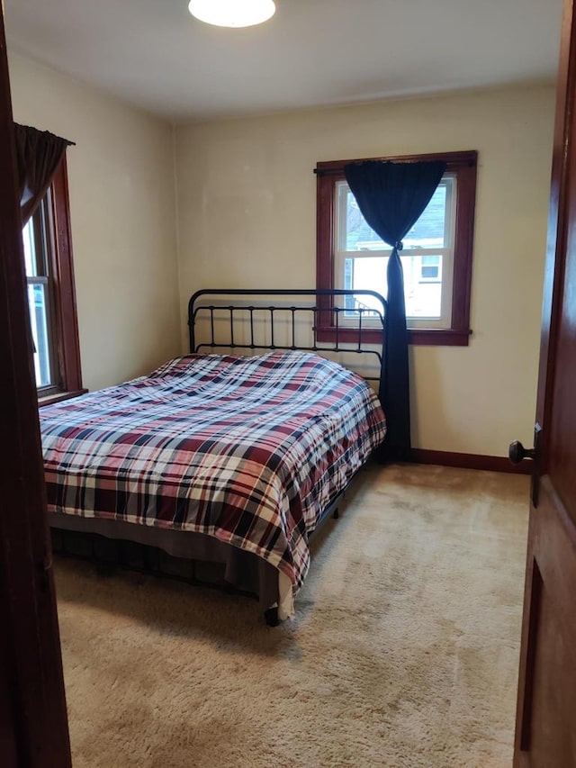 bedroom with baseboards and carpet floors