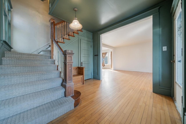 stairs featuring baseboards and hardwood / wood-style flooring