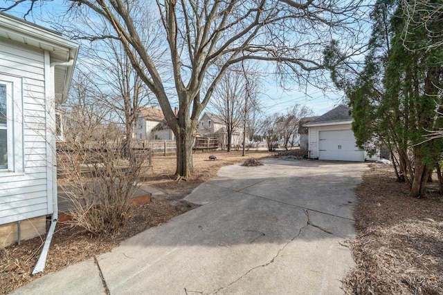 view of yard with a garage and concrete driveway