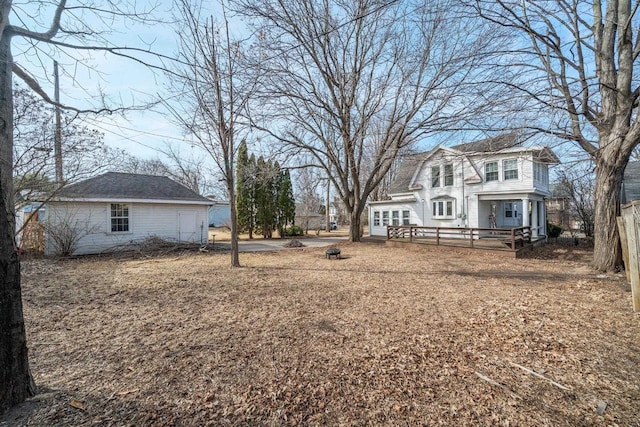 view of yard featuring an outdoor fire pit and a wooden deck