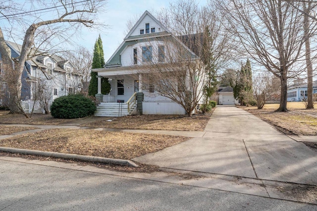 view of front facade with covered porch, concrete driveway, and a garage