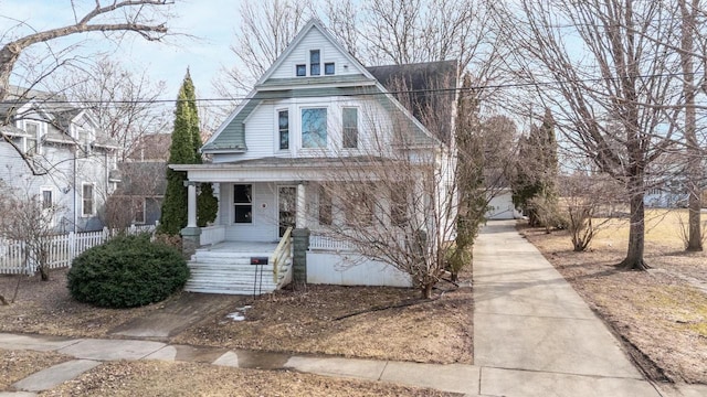 view of front of house with covered porch and fence