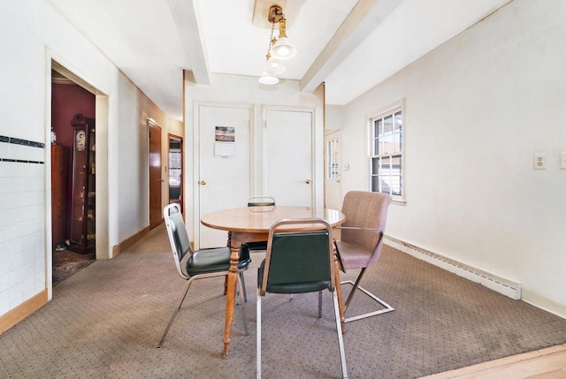 carpeted dining area featuring beam ceiling, baseboard heating, tile walls, and baseboards