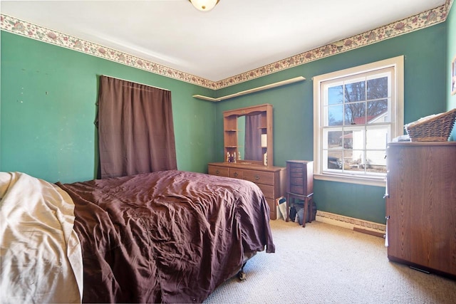 bedroom with baseboards and carpet floors