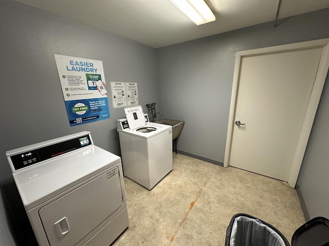 common laundry area featuring washer and dryer and a sink