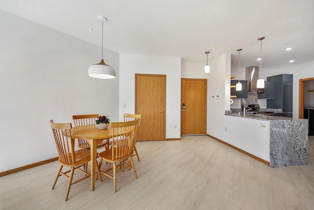 dining area featuring recessed lighting, baseboards, and light wood-style floors