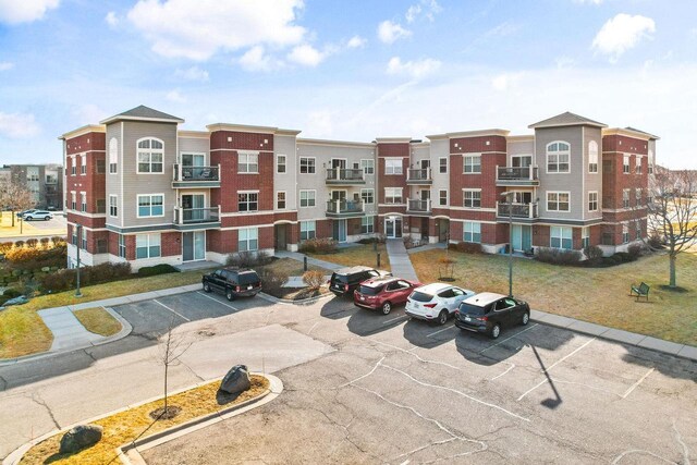 view of building exterior featuring uncovered parking