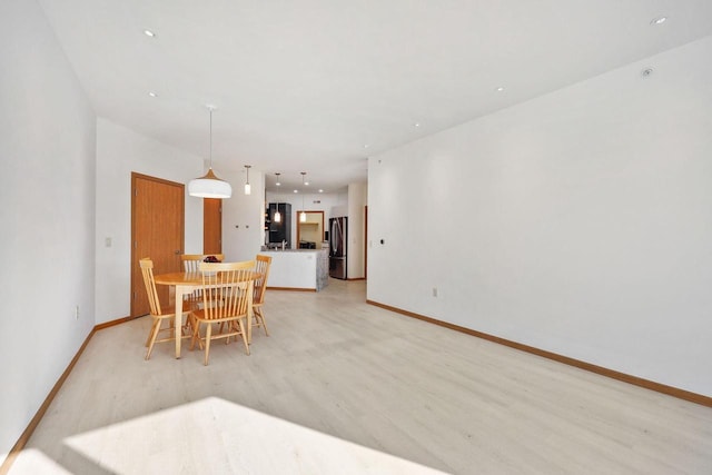 dining area featuring recessed lighting, light wood-type flooring, and baseboards