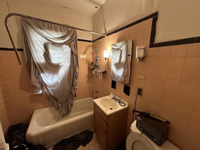 full bath featuring shower / bath combination with curtain, tile walls, vanity, and toilet