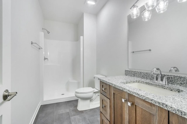 bathroom featuring baseboards, toilet, tile patterned floors, vanity, and a shower