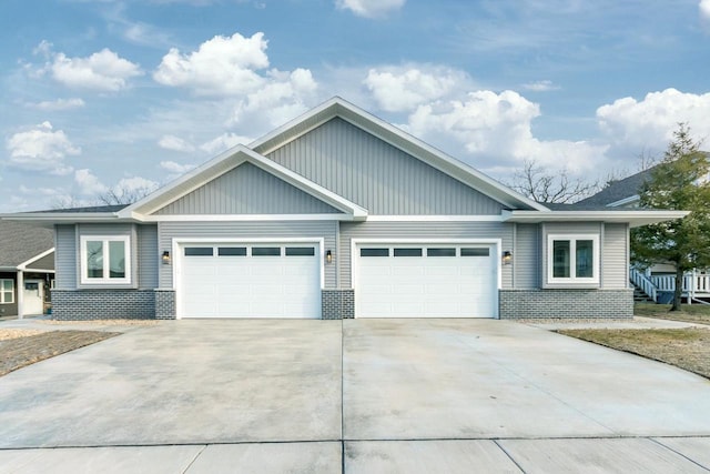 view of front of house with concrete driveway, an attached garage, and brick siding