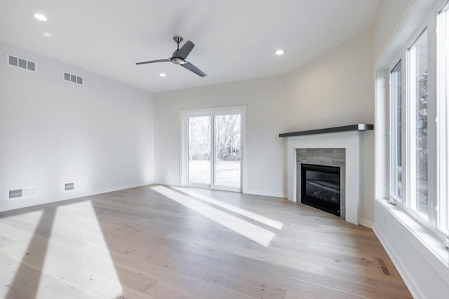 unfurnished living room with light wood-style flooring, visible vents, and ceiling fan