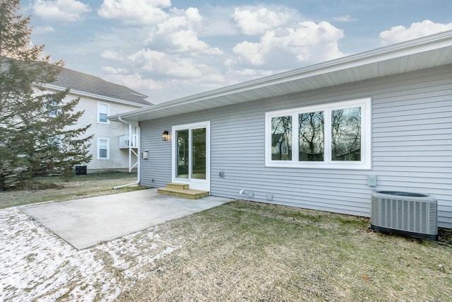 rear view of house with a patio area, a lawn, entry steps, and central AC