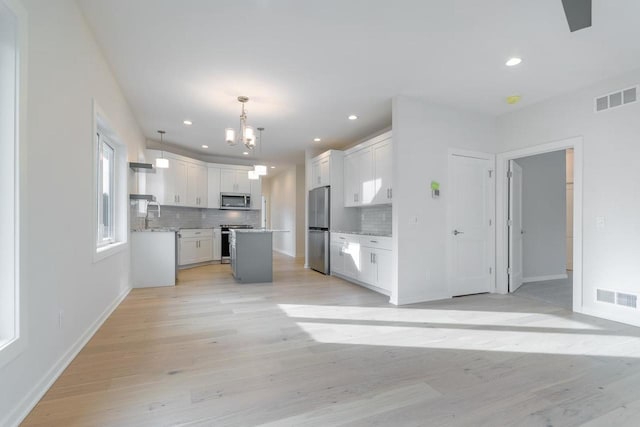 kitchen featuring a notable chandelier, visible vents, white cabinets, and appliances with stainless steel finishes