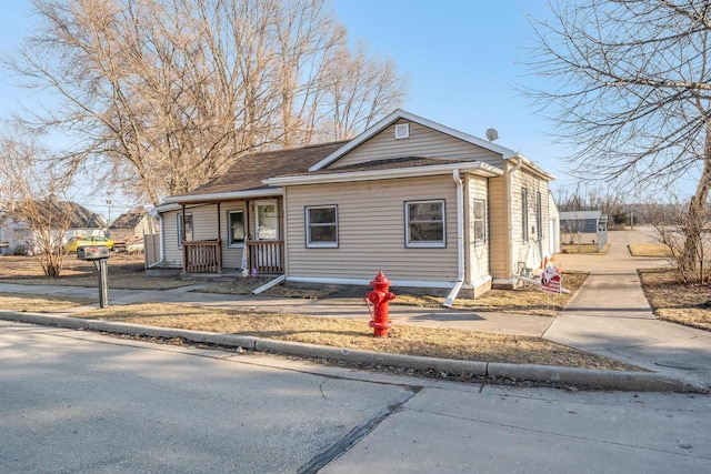 bungalow featuring a porch and driveway