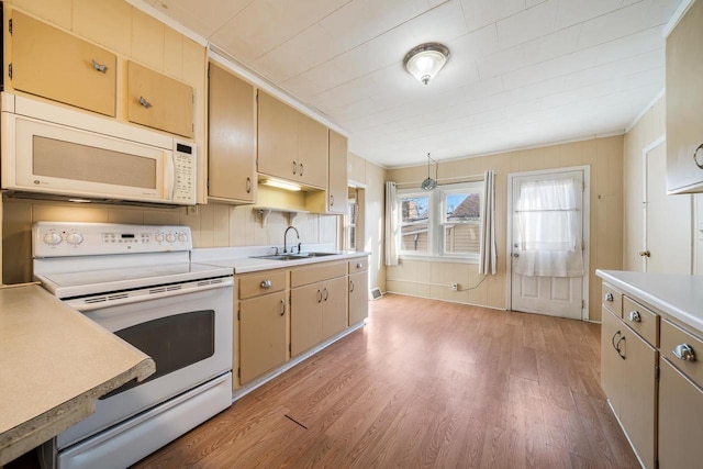 kitchen with white appliances, light wood-type flooring, and light countertops