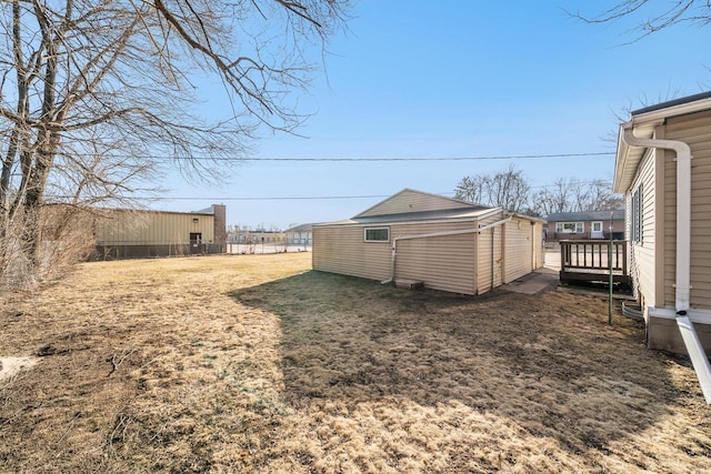 view of yard with an outbuilding and fence