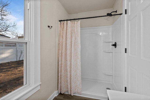 bathroom featuring curtained shower and wood finished floors