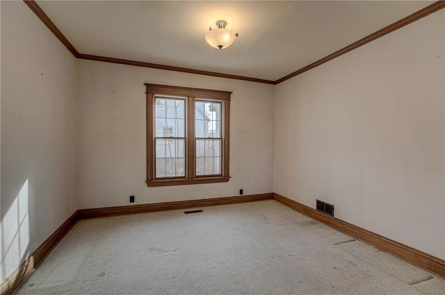 empty room featuring visible vents, carpet floors, baseboards, and ornamental molding