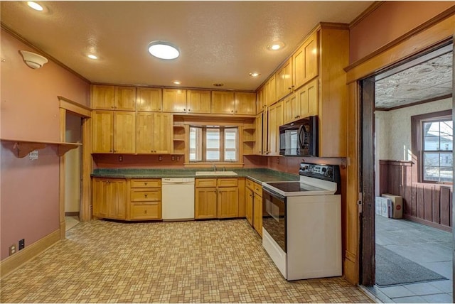 kitchen with ornamental molding, open shelves, dark countertops, white appliances, and wainscoting