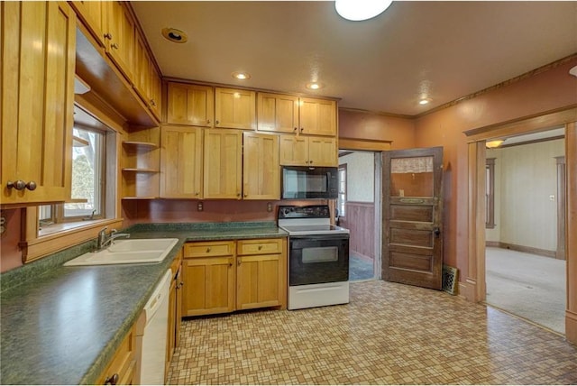 kitchen with dark countertops, black microwave, dishwasher, range with electric stovetop, and a sink