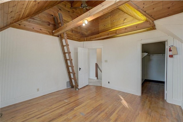 interior space with lofted ceiling with beams, wood ceiling, and wood-type flooring