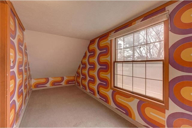 recreation room featuring lofted ceiling, a textured ceiling, and carpet flooring