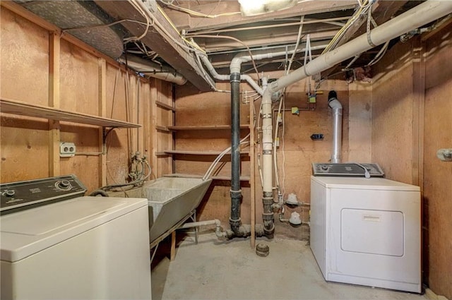 laundry area featuring a sink, laundry area, and washing machine and clothes dryer