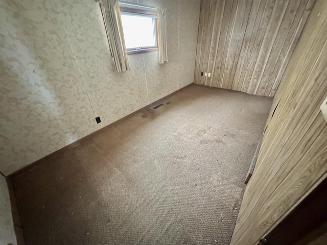 carpeted empty room with visible vents