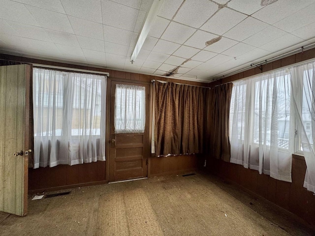 empty room featuring wood walls