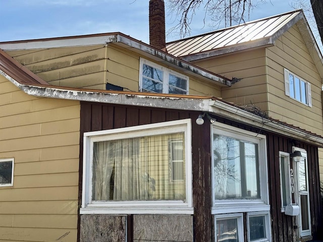 view of property exterior with a chimney