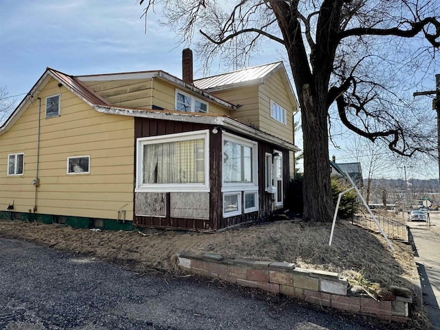 view of side of home featuring a chimney