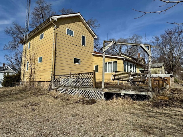 rear view of property with a wooden deck