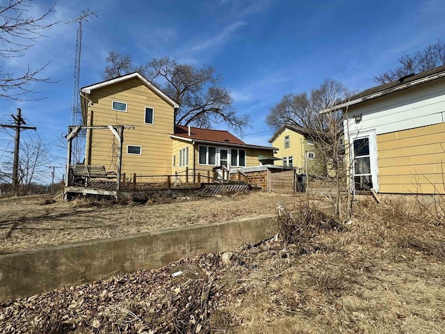 rear view of property with metal roof and a deck