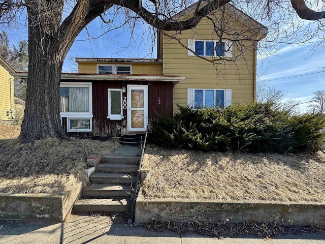 traditional-style home with entry steps and board and batten siding