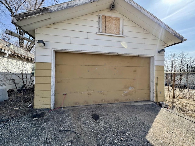 detached garage featuring fence