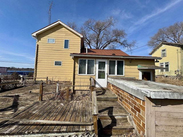 back of house with a deck and metal roof