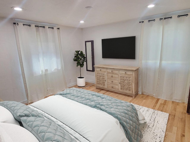 bedroom with recessed lighting and light wood-style floors