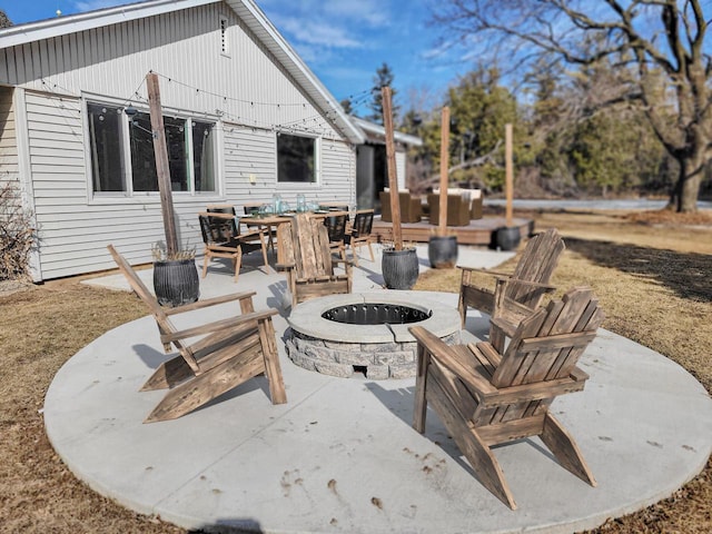 view of patio / terrace with a fire pit and outdoor dining area