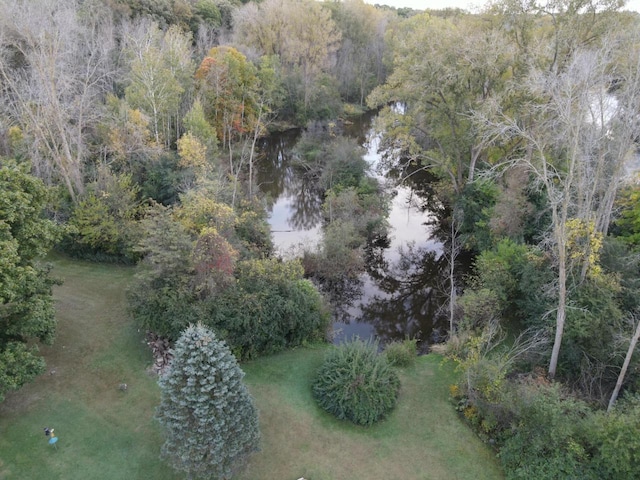 birds eye view of property featuring a wooded view and a water view