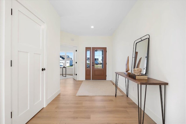 foyer entrance featuring recessed lighting, light wood-style floors, and baseboards