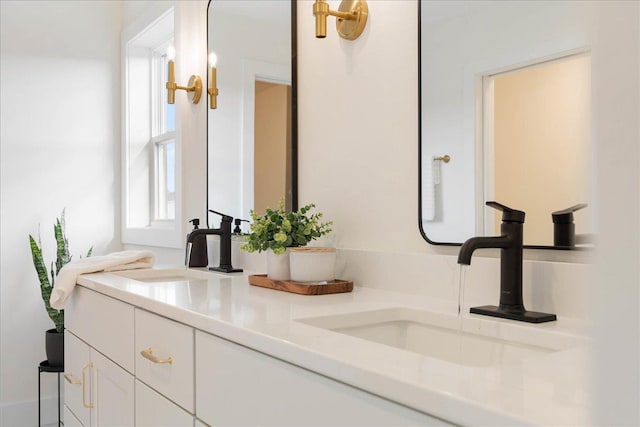 full bathroom with double vanity and a sink